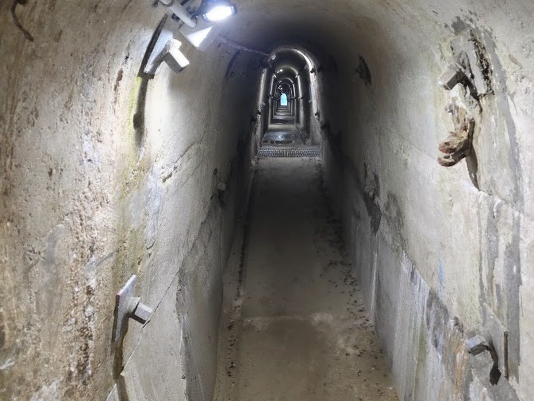 Falls Dam Redevelopment — lit concrete inspection gallery inside the dam